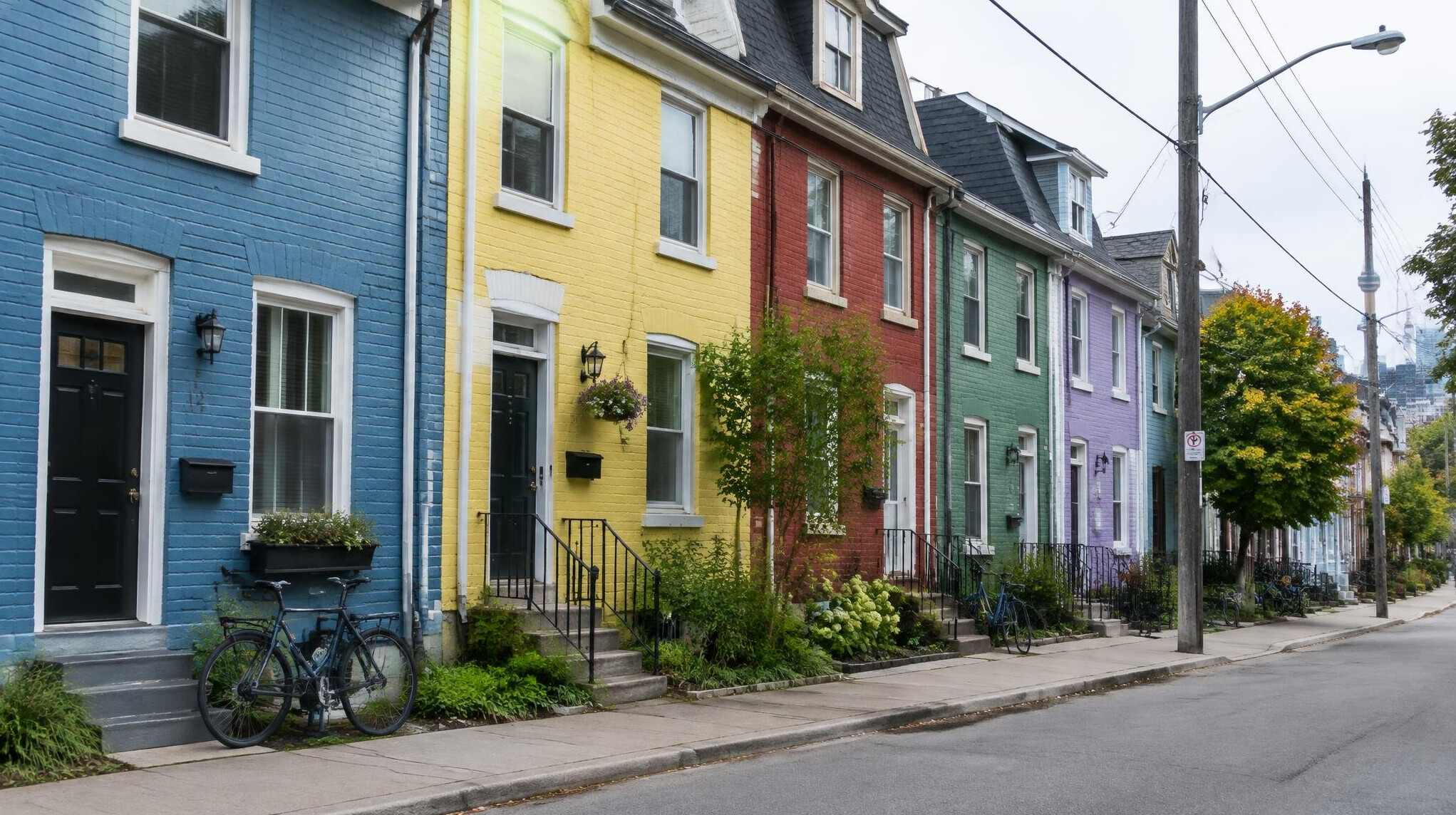 Row of colourful attached houses on a quiet Canadian street